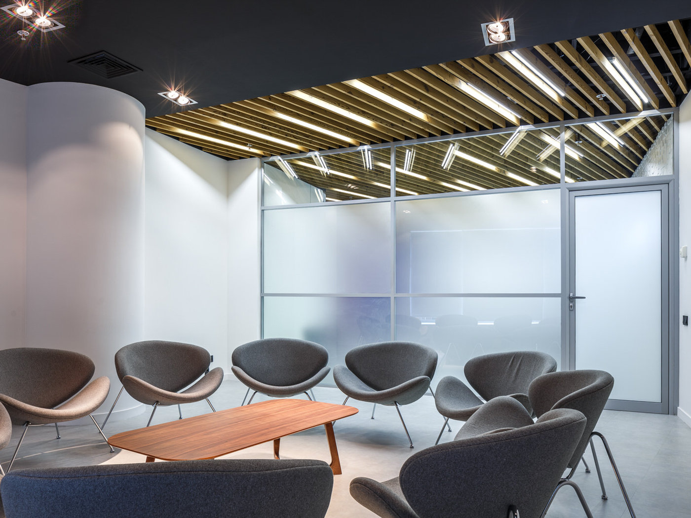 Contemporary office lounge with designer armchairs photographed in architectural light